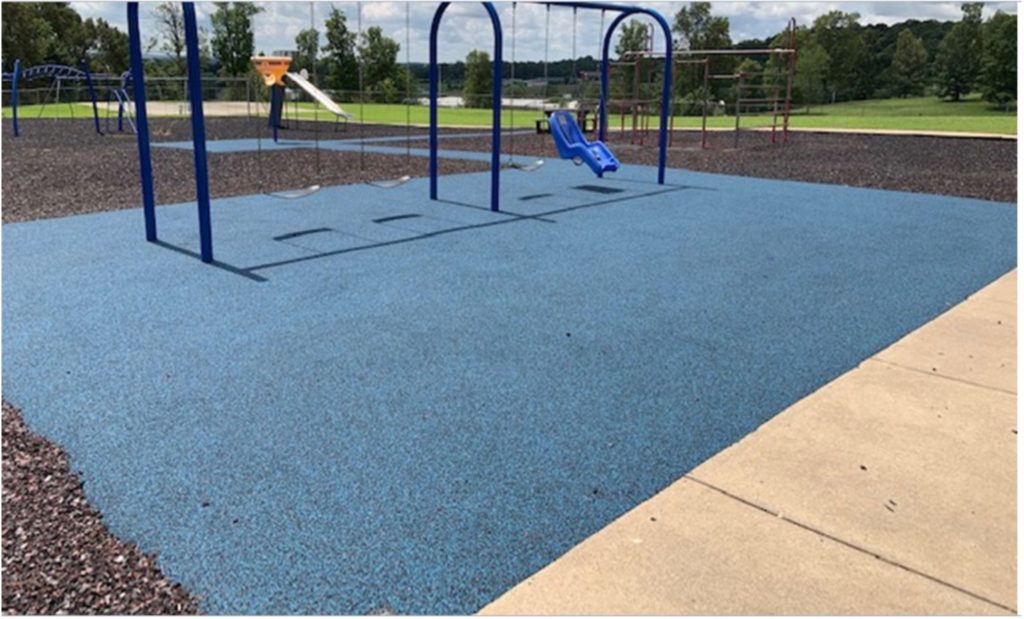 a playground in Kentucky with a crumb rubber play surface